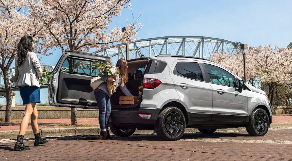A white 2022 Ford EcoSport parked near a bridge.