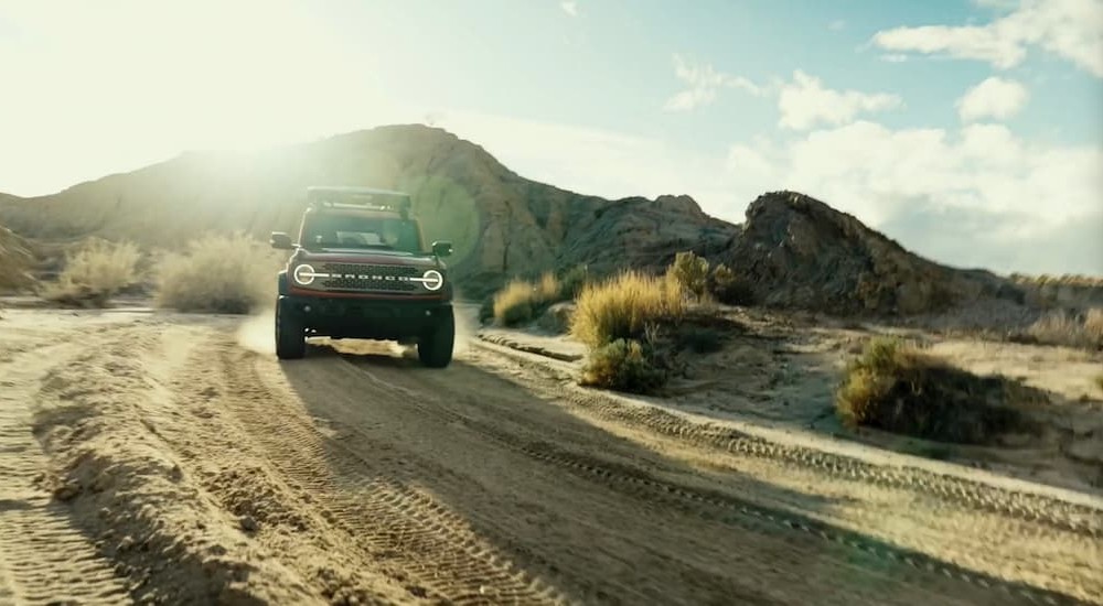 A red 2026 Ford Bronco off-roading.