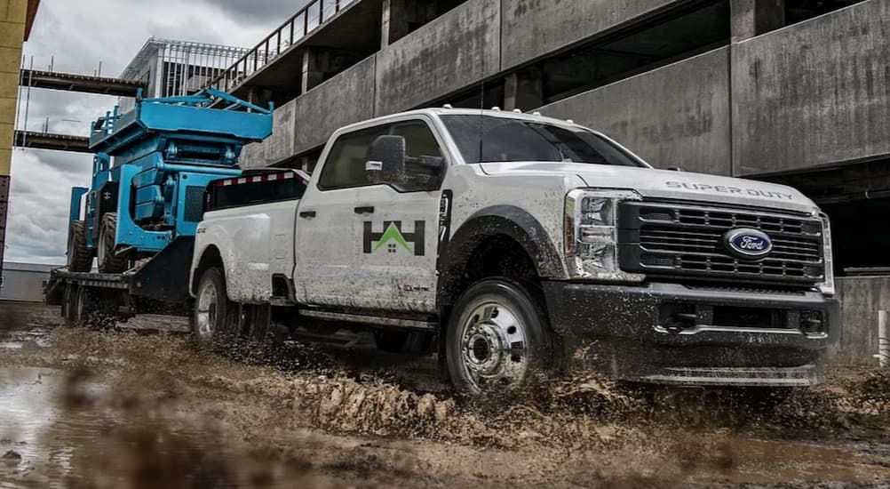A white 2026 Ford F-350 towing a trailer.