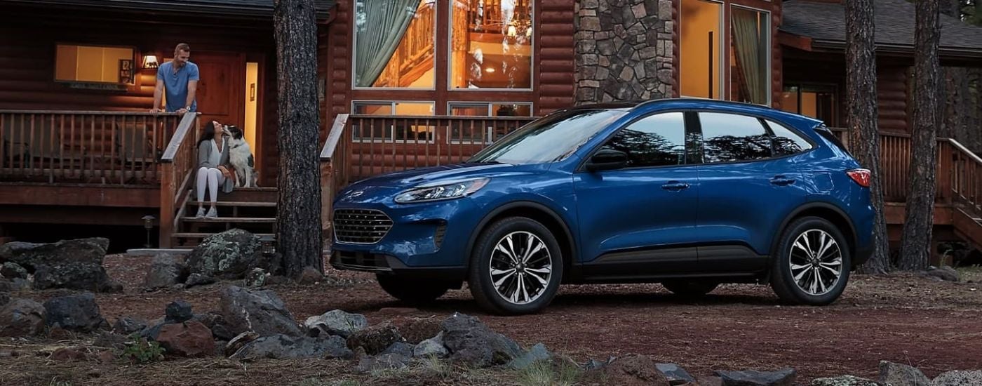 Blue 2022 Ford Escaped parked at an angle in front of a cabin
