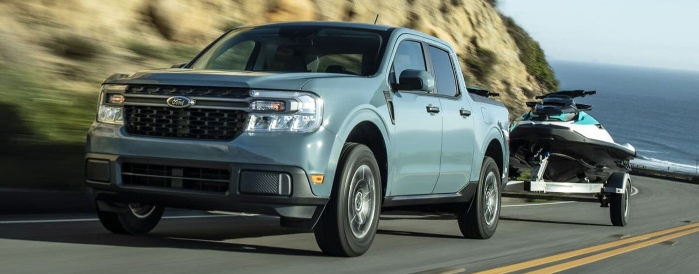 Blue 2022 Ford Maverick driving up an open road