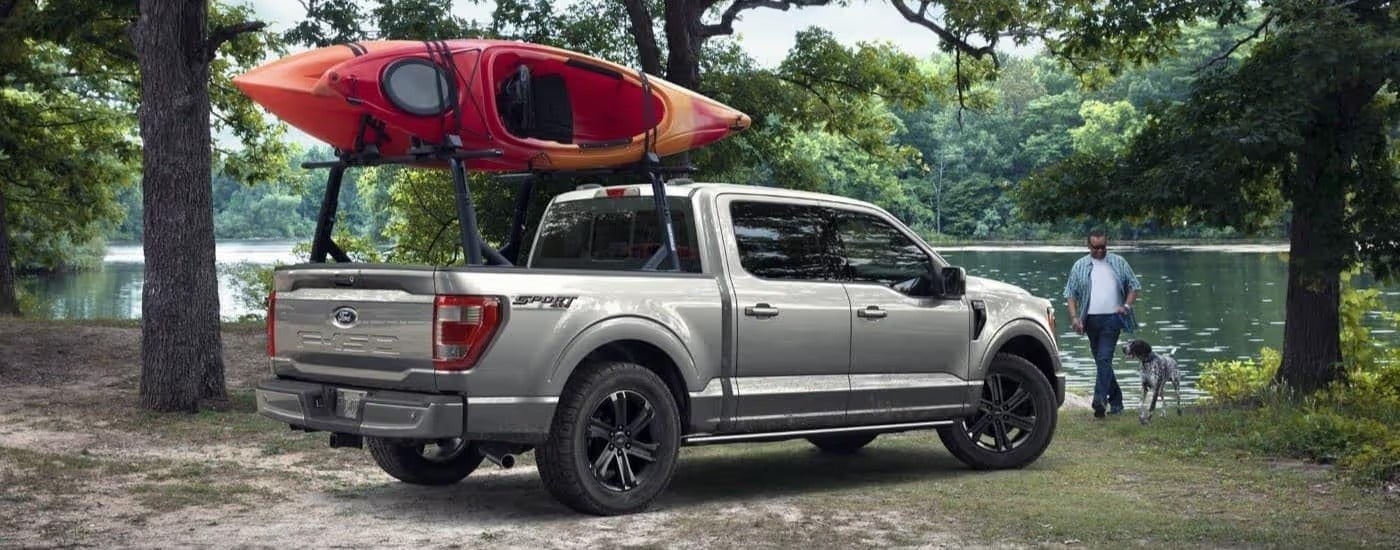 Silver 2023 Ford F-150 Sport with a kayak in the bed