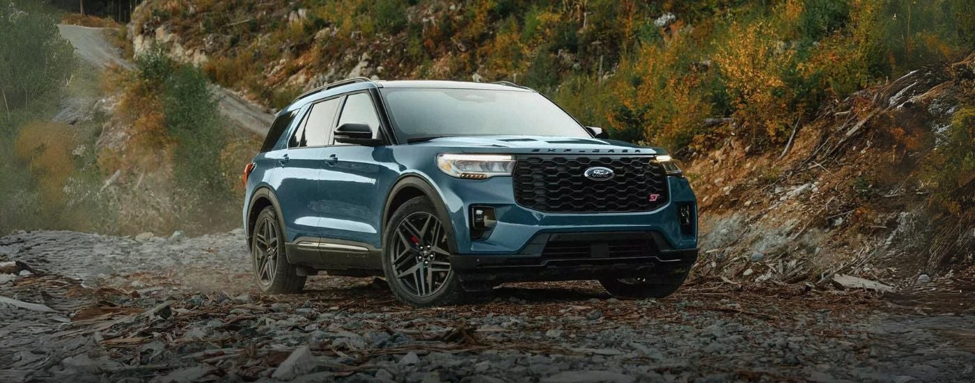 Blue 2026 Ford Explorer ST parked off-road at an angle