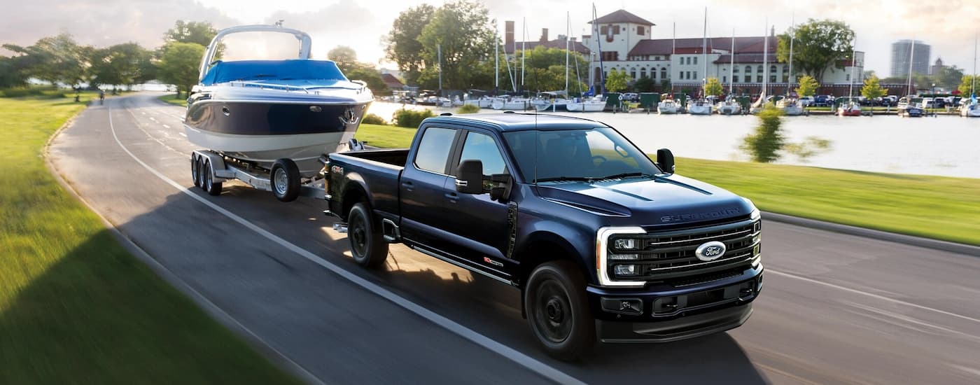 Black 2026 Ford F-350 towing a boat.