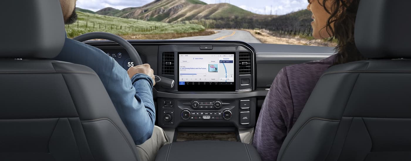Two people sitting inside a 2026 Ford F-350.