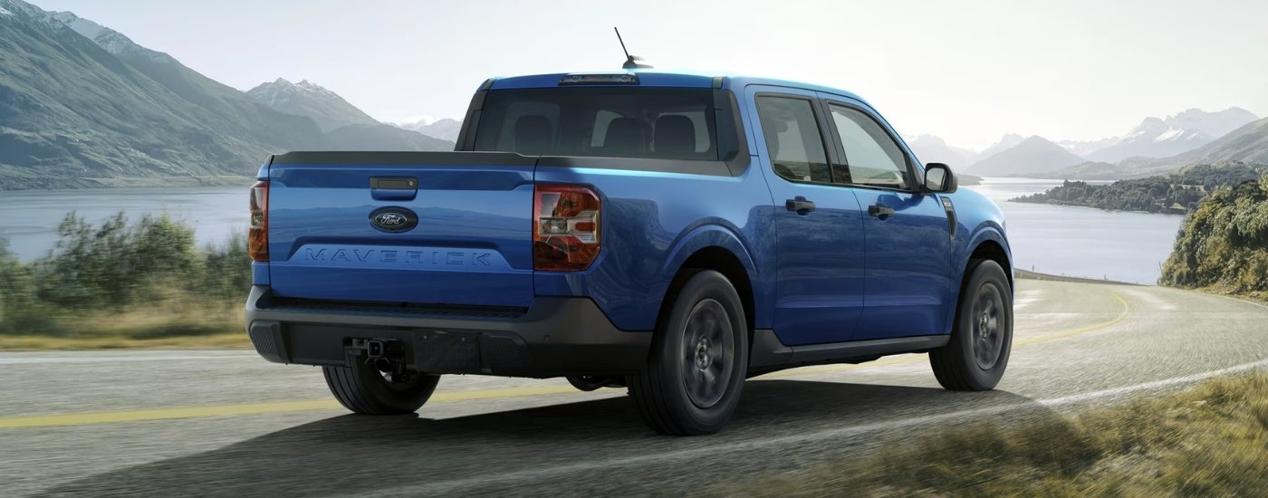 Blue 2025 Ford Maverick driving down an open road
