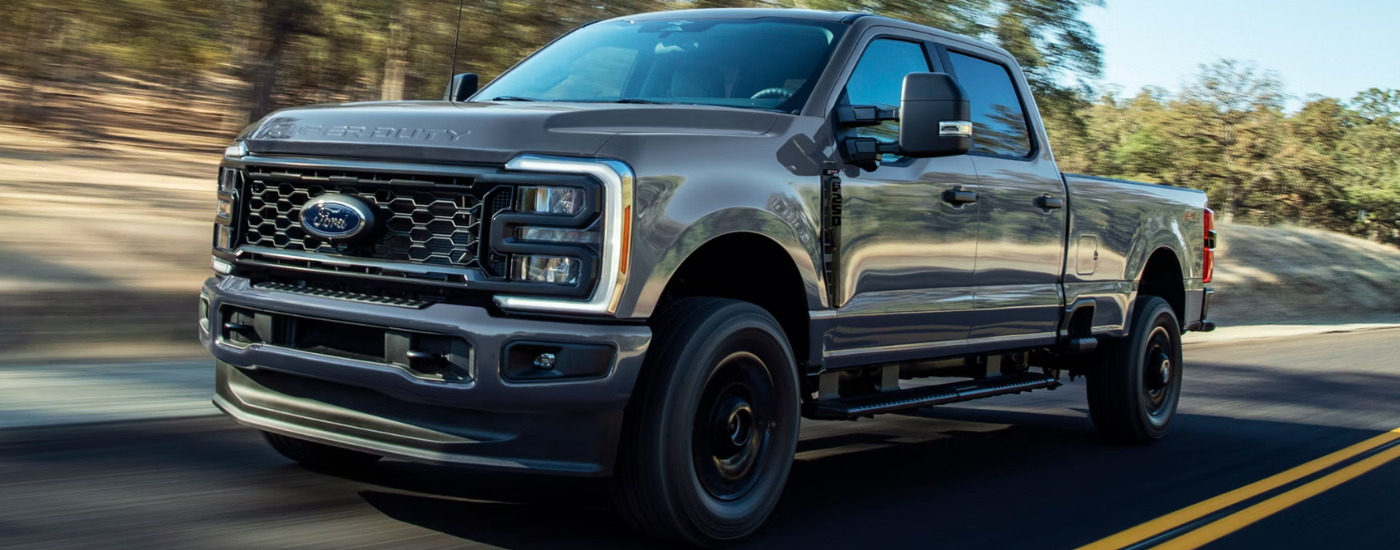 Grey 2026 Ford F-250 Super Duty driving on an open road