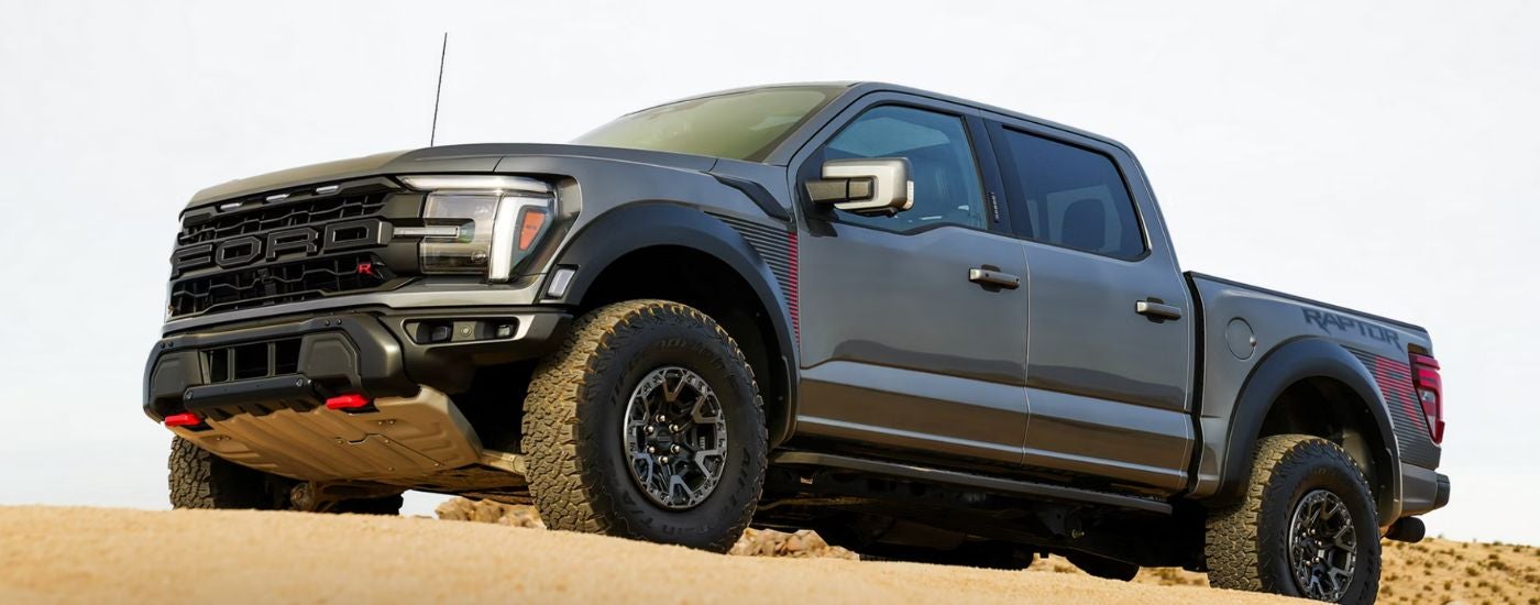 A gray 2026 Ford F-150 Raptor R model is parked in the desert.